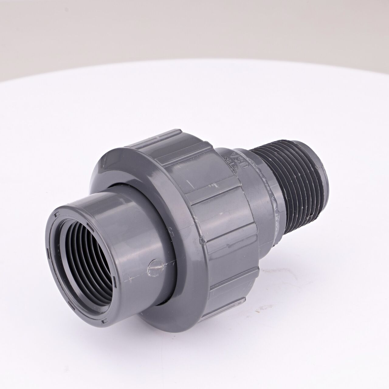 One end of the PVC Union, 1 in. Sch. 80 FPT X MPT which connects two 1 in. Sch. 80 pipes together to allow water to flow through while preventing leaks (NDS U-1000-TM)