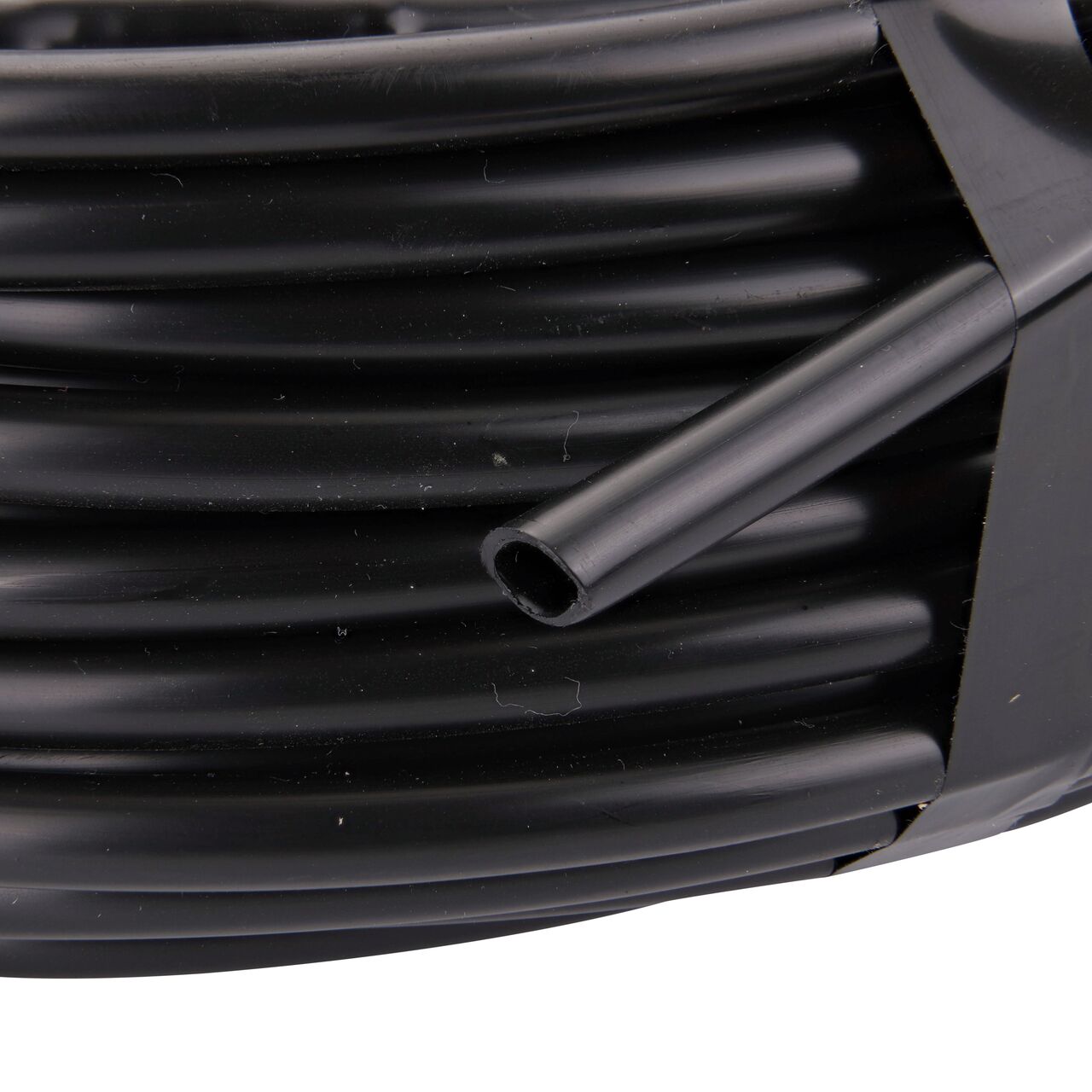 Closeup of the outside end of the NDS Black 100 ft. 1/4 in. Dura Flo™ JR Dripline with 12 in. spaced 0.5 GPH Non-Pressure Compensating Emitters (NDS SFJR-BL-12-01)