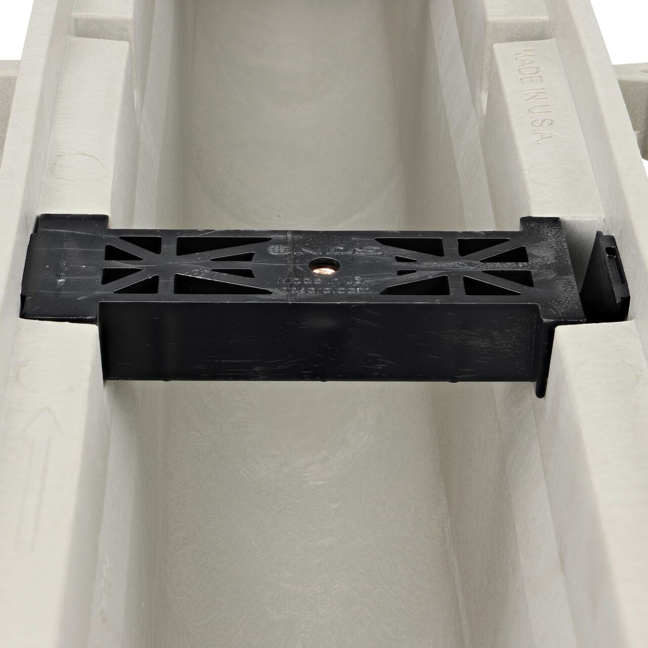 Closeup view of the grate locking system on the NDS Dura Slope Neutral Channel Drain, which locks grate to the integral frame (NDS DS-103N, NDS DS-104, NDS DS-105, NDS DS-106)