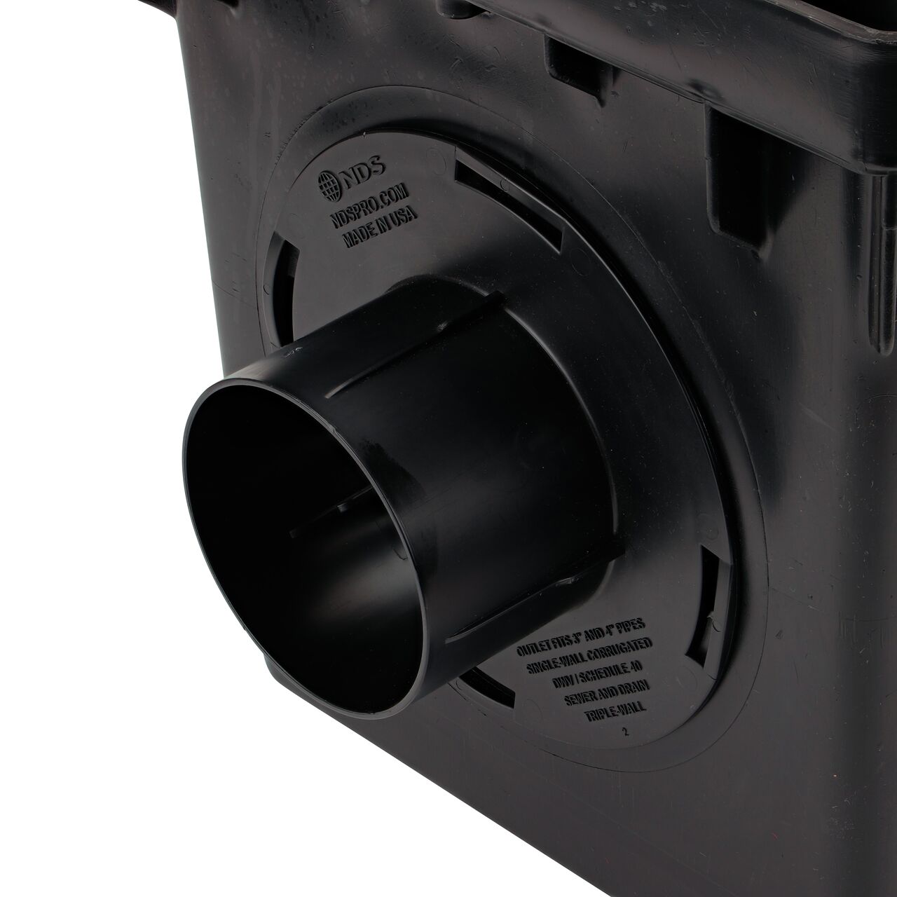 Closeup of the retail (NDS 1244*) Outlet Adapter for Catch Basin Drain which fits 3 in. & 4 in. Drain Pipes, installed on the 3-outlet 12 in. Catch Basin Drain (NDS 1203)