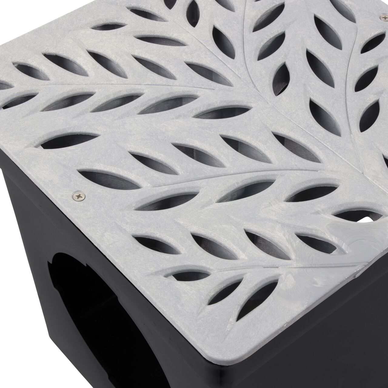 Closeup view of NDS 12 in. Square Catch Basin Drain Grate, Decorative Botanical Design, Gray Plastic (NDS 1218GY) and how it fits securely within a 12 in. Square Catch Basin Drain with 2 Openings (NDS 1200*); retail
