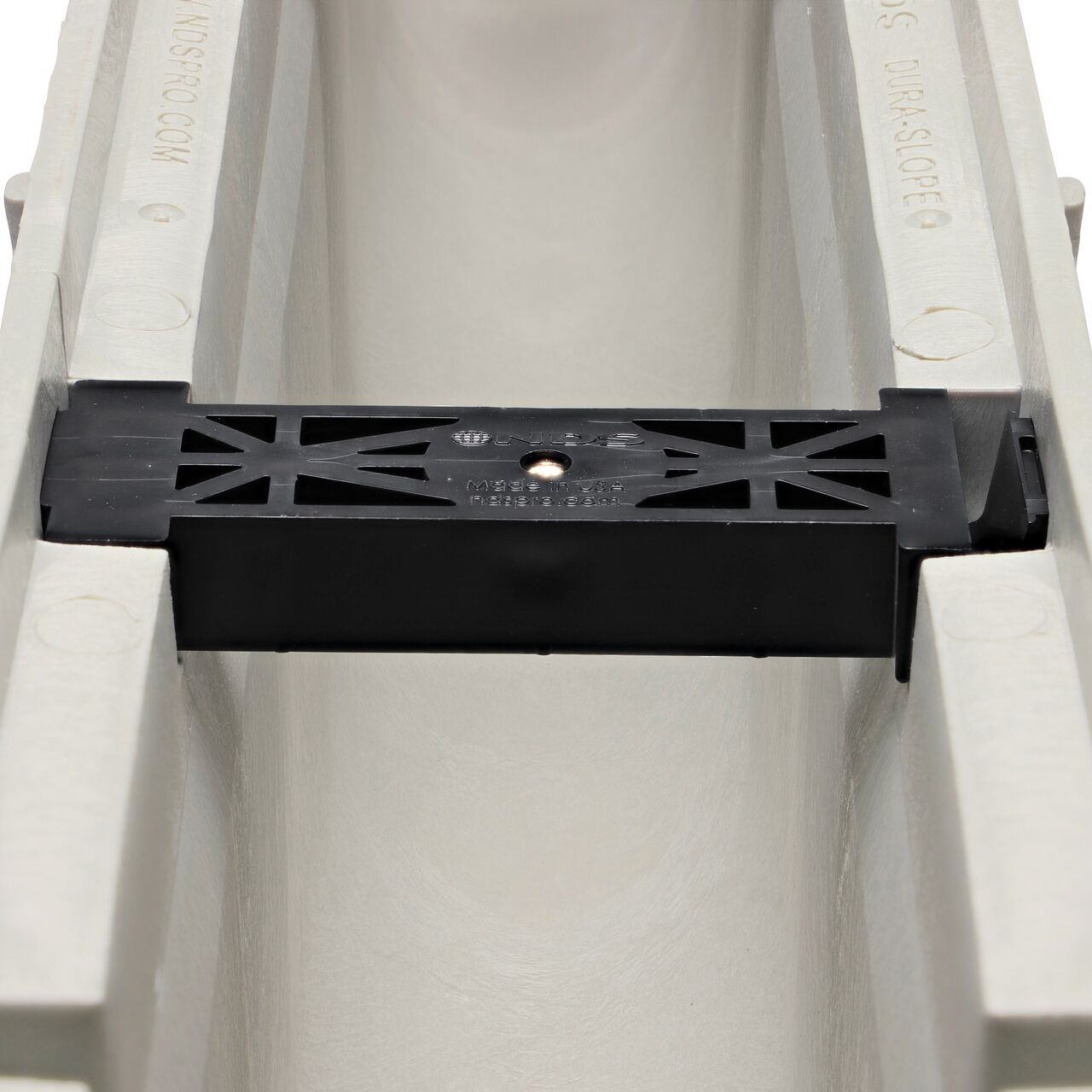Closeup view of the grate locking system on the NDS Dura Slope Channel Drain, which locks grate to the integral frame (NDS DS-106N0