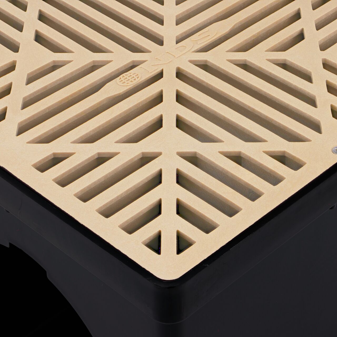 Closeup view of the NDS 12 in. Sand Square Catch Basin Drain Grate (NDS 1212SRTL, NDS H1212S) installed on a NDS 12 in. Square Catch Basin (NDS 1200*); retail