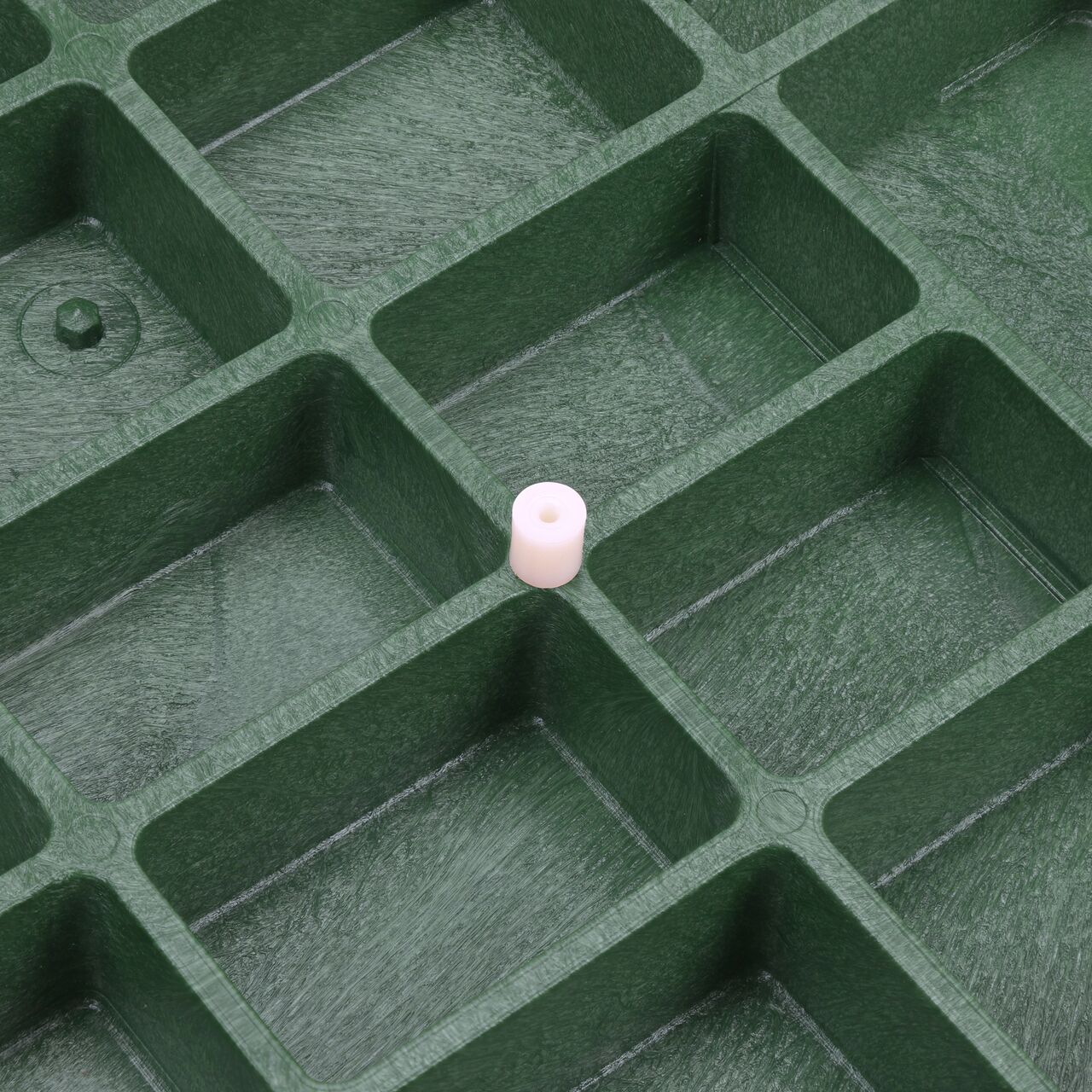The electronic marker disc sits on a piece on the underside of the telecom cover for the NDS 17 in. X 30 in. Rectangular Pro-Spec® Series Telecom Box (NDS 326BCBT-BG-M) before being screwed securely to the lid