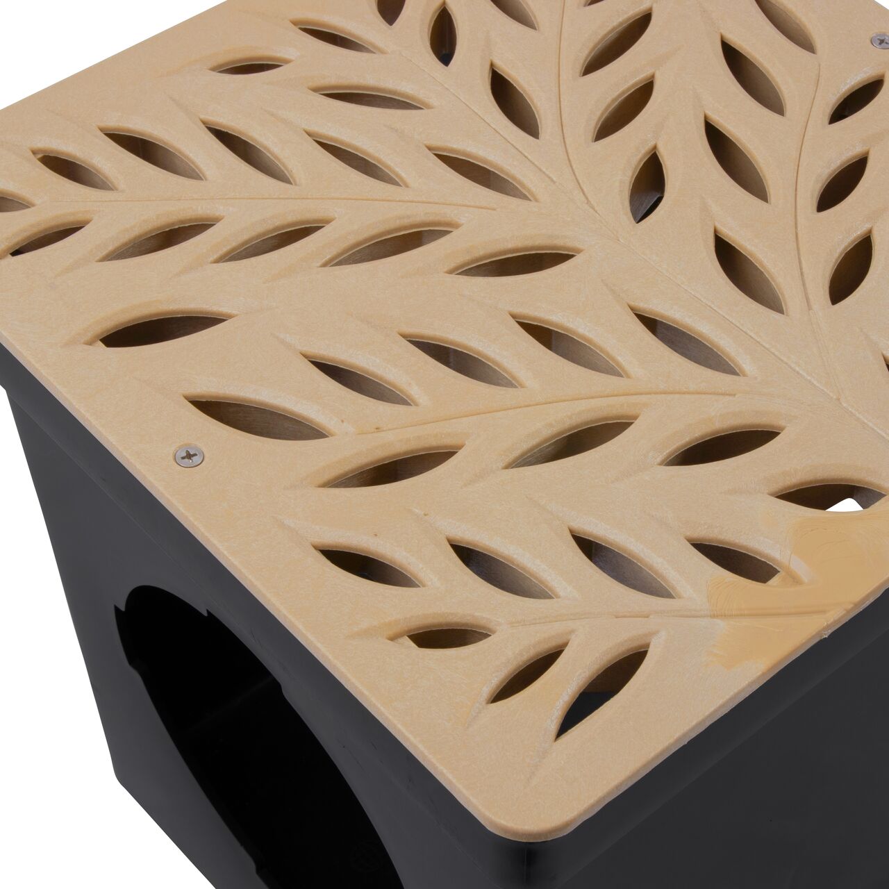 Closeup view of NDS 12 in. Square Catch Basin Drain Grate, Decorative Botanical Design, Sand Plastic (NDS 1218s) and how it fits securely within a 12 in. Square Catch Basin Drain with 2 Openings (NDS 1200*); retail
