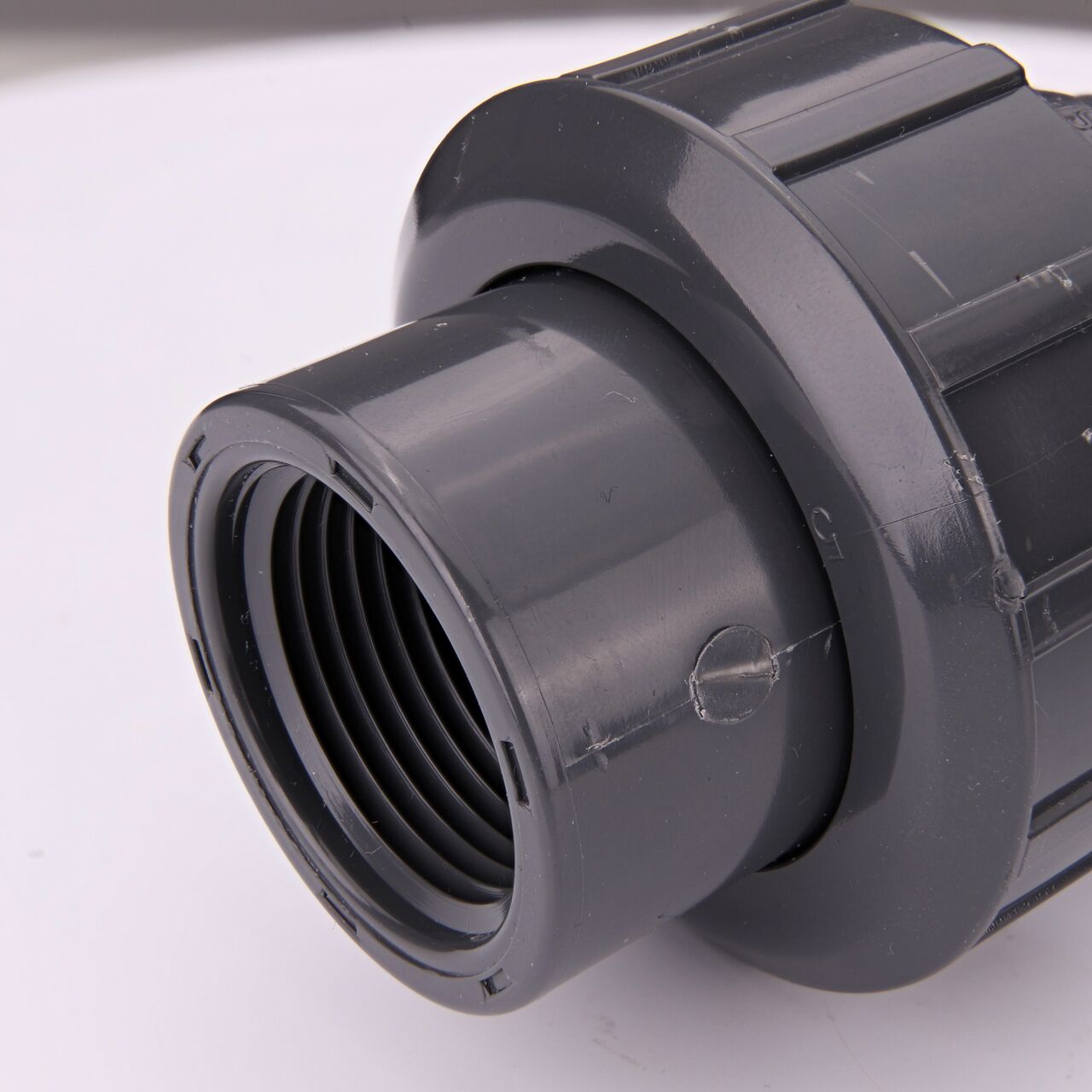 Closeup view of the other threaded end on the PVC Union, 1 in. Sch. 80 FPT X MPT (NDS U-1000-TM) which provides a corrosion-free connection between pipes and prevents costly property damage
