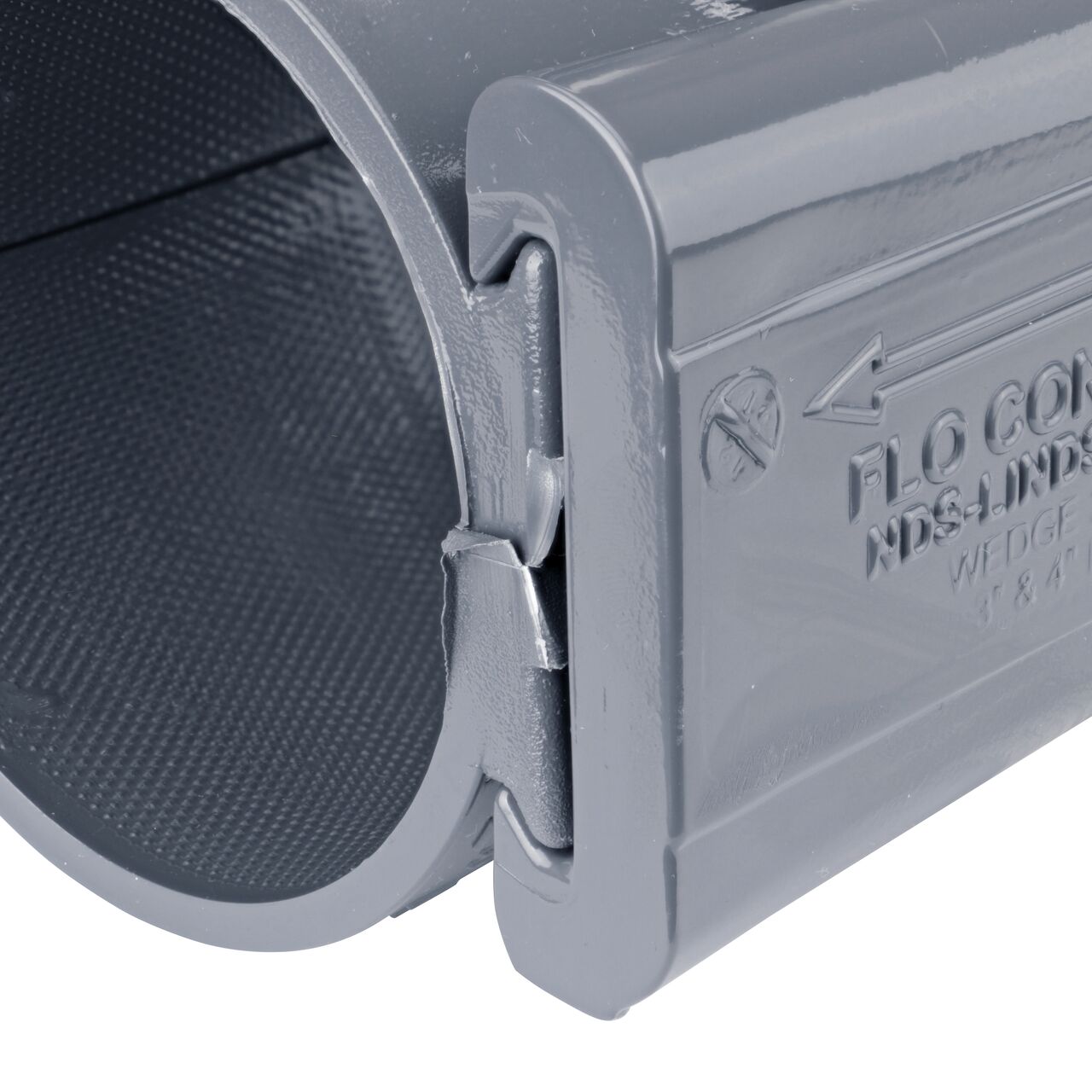 Closeup of the wedge installed securely on the NDS Clamp-It™ Rigid PVC Saddle with 3/4 in. FPT connection on top (NDS 443007) for 3 in. PVC pipe