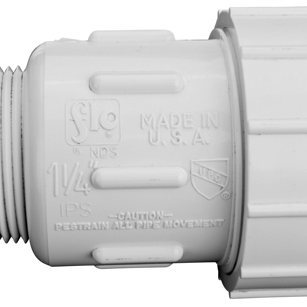 Closeup view of the NDS PVC Compression Adapter, 1-1/4 in. IPS UC X 1-1/4 in. IPS MPT showing that it is made in the USA as part of a complete flow management system for pool, spa, irrigation, and plumbing applications (NDS CPA-1250)