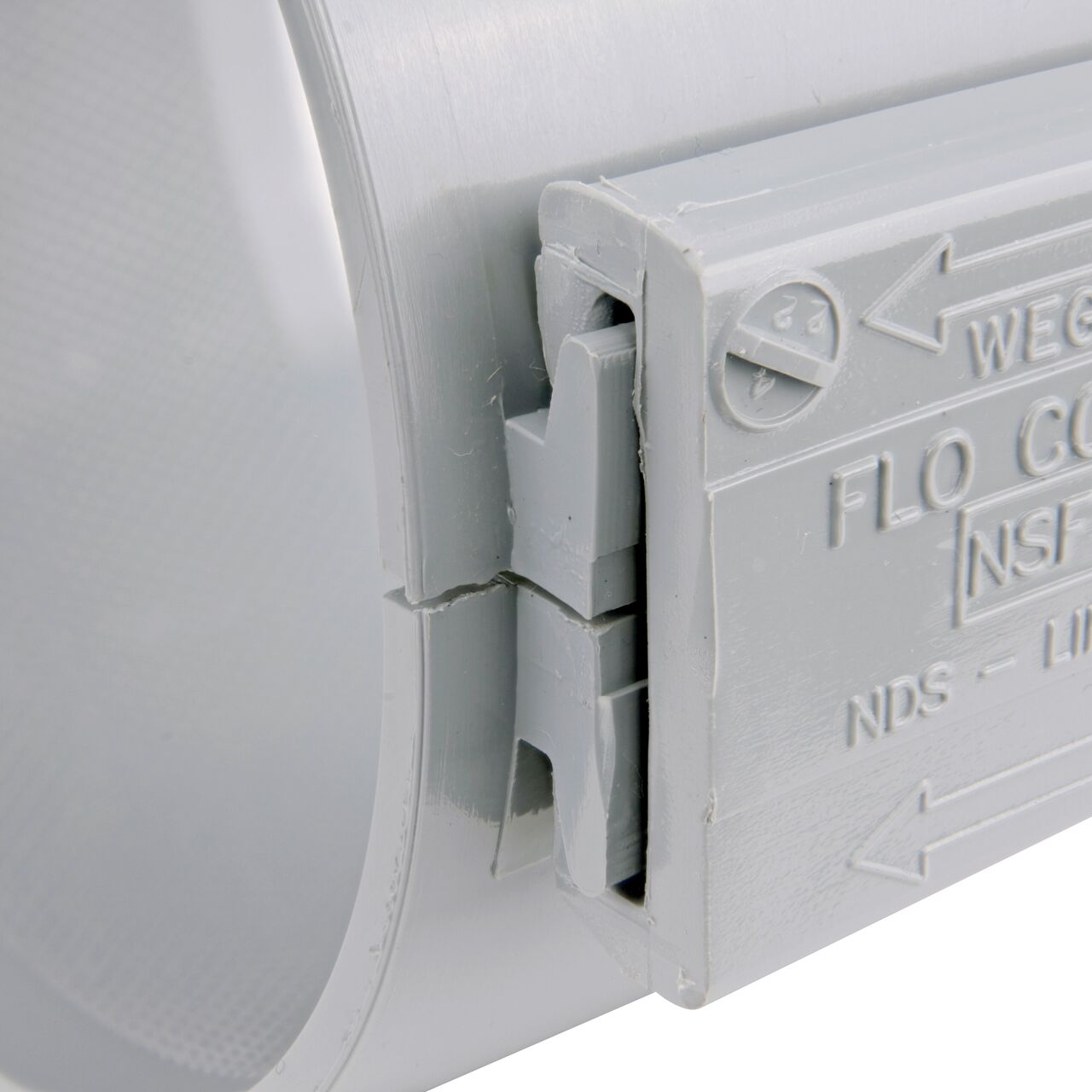 Closeup of the wedge installed securely on the the NDS Clamp-It™ Rigid PVC Saddle for 4 in. PE pipe with 3/4 in. FPT connection on top (NDS 344007P)
