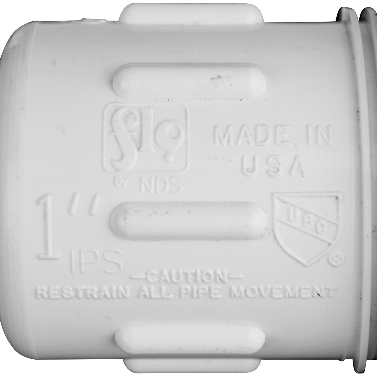 Closeup view of the NDS PVC Compression Adapter, 1 in. IPS UC X 1 in. IPS MPT showing that it is made in the USA as part of a complete flow management system for pool, spa, irrigation, and plumbing applications (NDS CPA-1000)