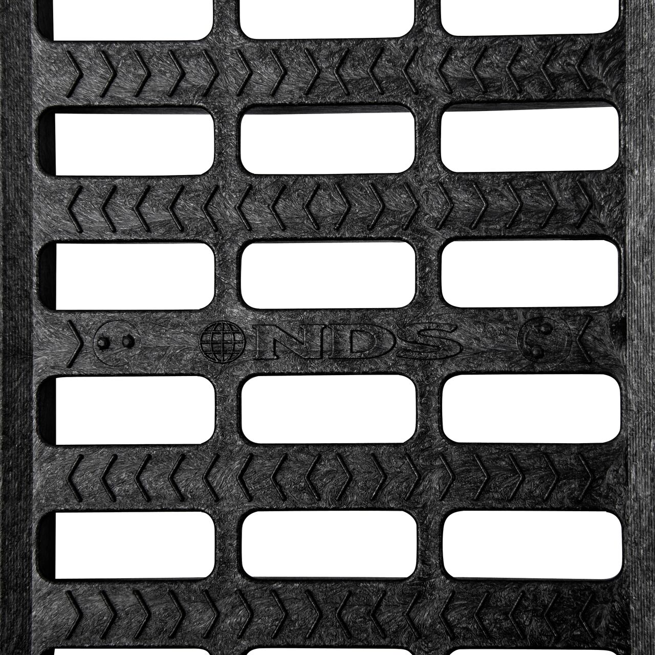Top down partial closeup of grate openings on NDS 5 in. Pro Series Channel Drain Grate in Black Plastic (NDS 816)