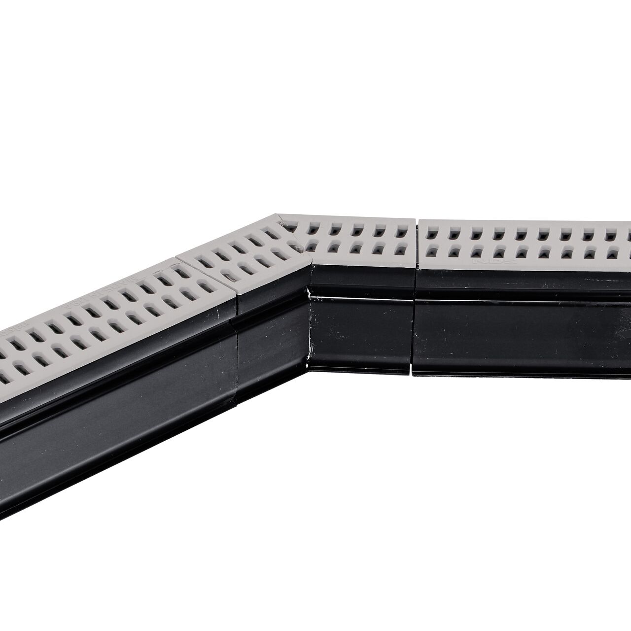 Installation shot with two channel drains and grates to the NDS Gray Slim Channel™ Drain 45° Elbow and Grate (NDS 9303)