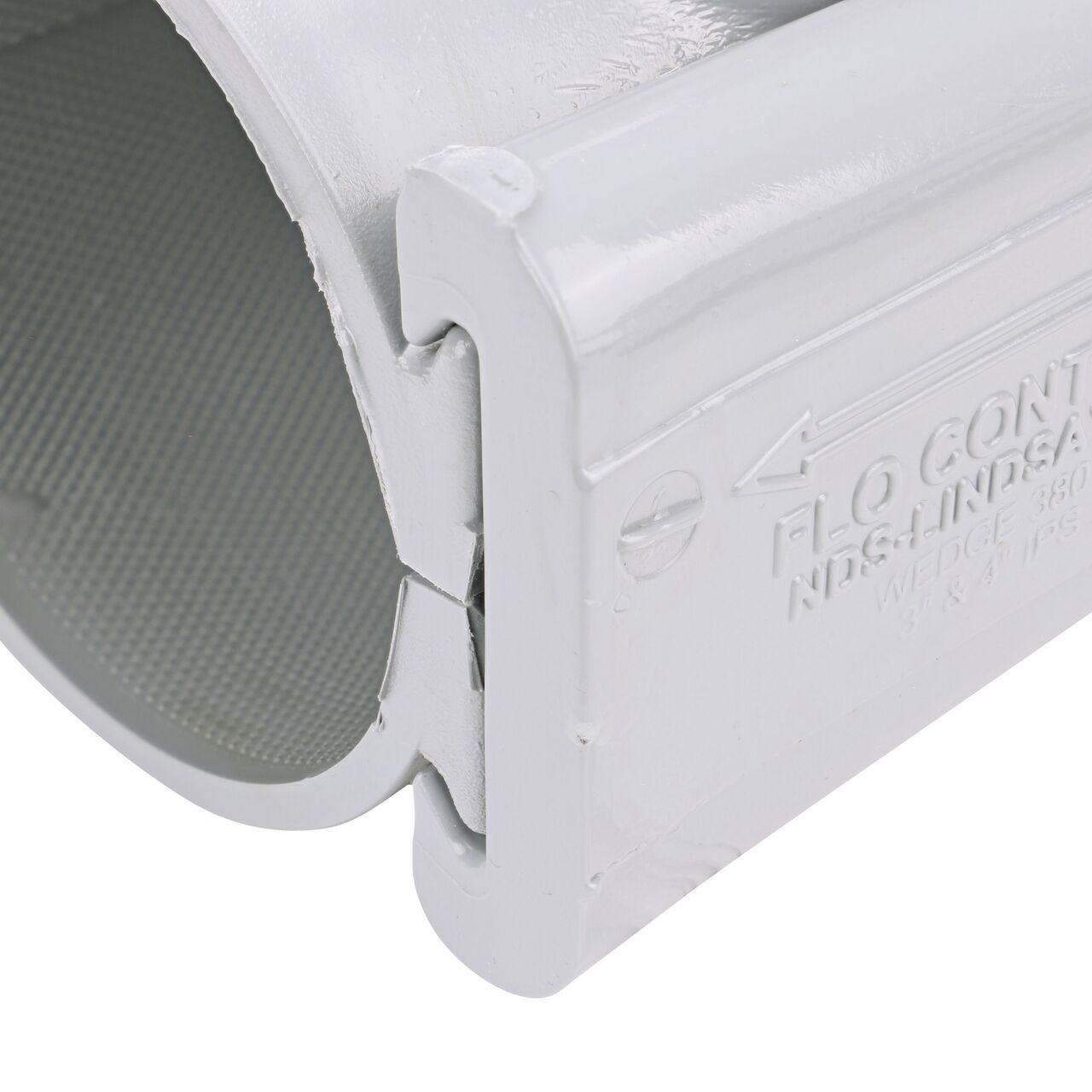 Closeup of the wedge installed securely on the NDS Clamp-It™ Rigid PVC Saddle with 1 in. FPT connection on top (NDS 443010) for 3 in. PVC pipe