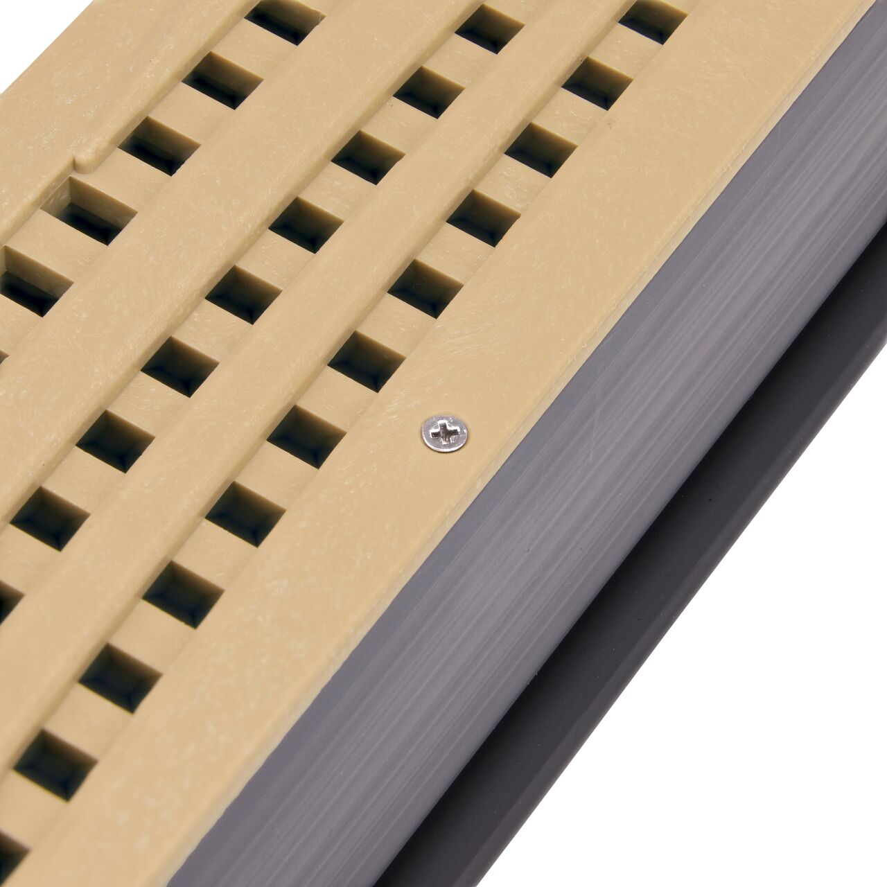 Closeup of the #4 X 1 in. Phillips Flat Head Screw securing plastic grate to mini channel (NDS 846)