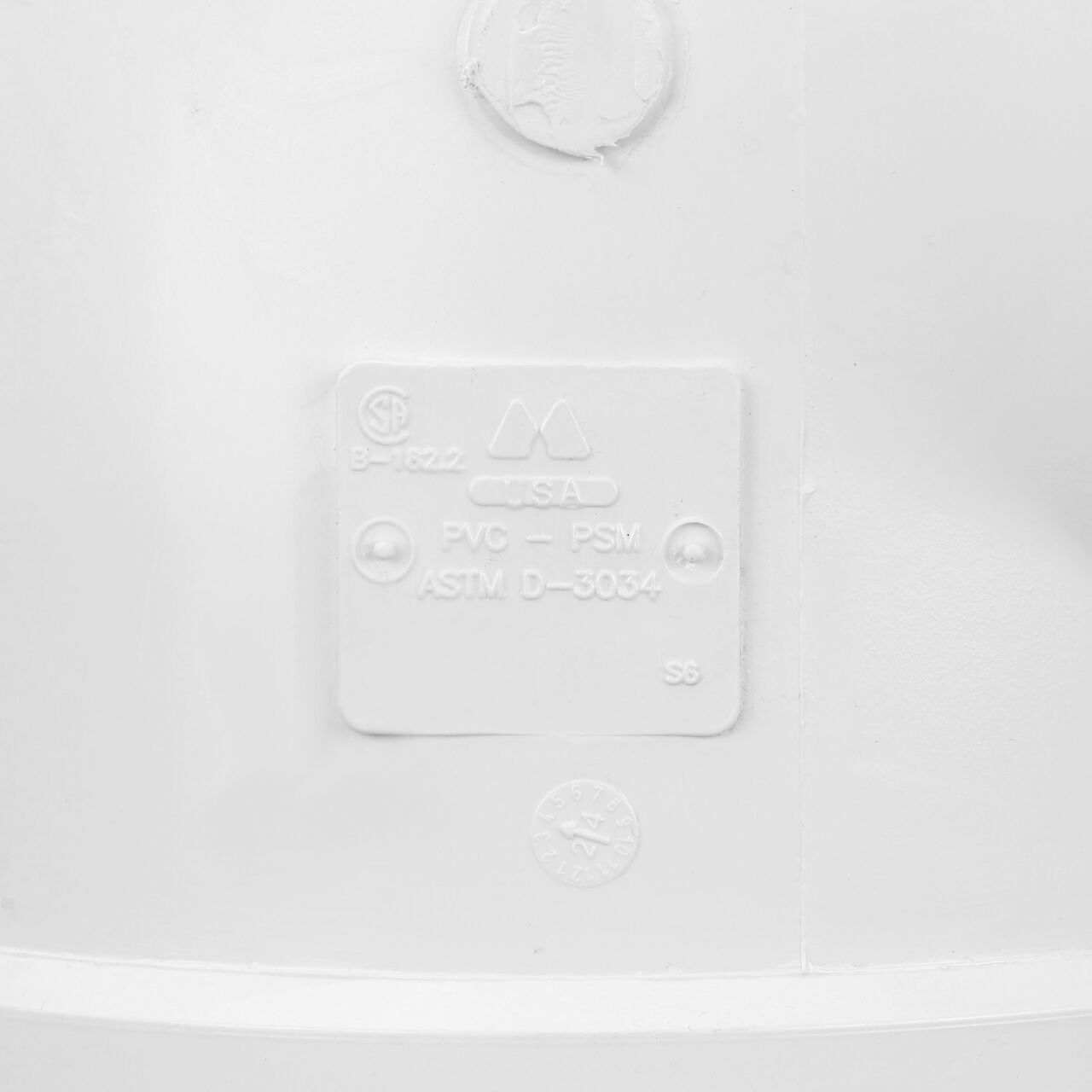 Closeup view of the markings on the NDS PVC 90° elbow, which connects 8 in. Sewer and Drain pipes, Hub X Hub (NDS 8P02)