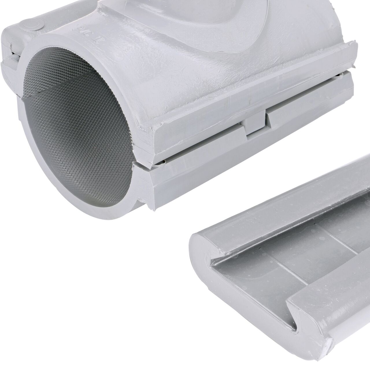 Closeup of the wedge latch uninstalled on the NDS Clamp-It™ Rigid PVC Saddle with 1 in. slip connection on top (NDS 432010) for 2 in. PVC pipe