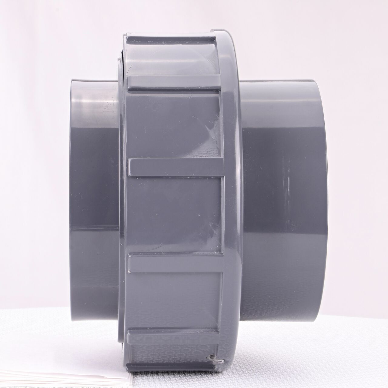 Side view of the NDS 4 in. PVC Union (NDS U-4000-T) shows both threaded ends and a pull-apart feature to quickly disconnect from pipes