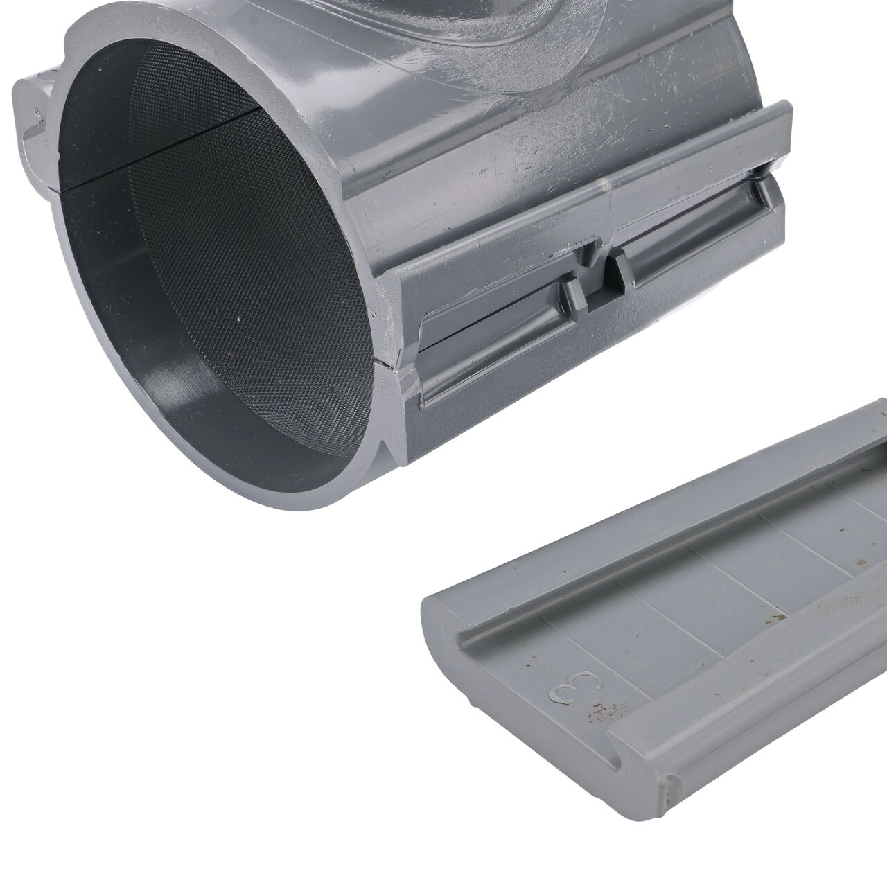 Closeup of the wedge latch uninstalled on the NDS Clamp-It™ Rigid PVC Saddle with 2 in. FPT connection on top (NDS 444020) for 4 in. PVC pipe