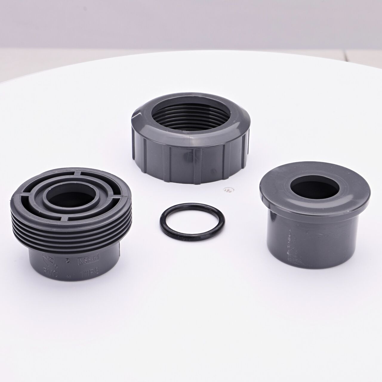 NDS PVC Union Ball Valve unassembled showing all the pieces including the Slip ends facing upwards that connect two 1 in. Sch. 80 pipes