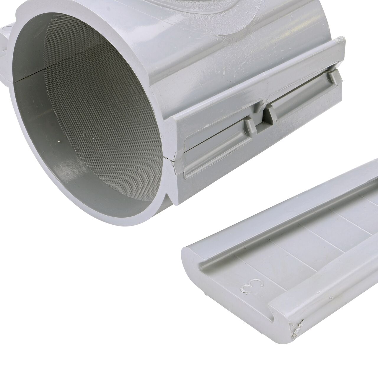 Closeup of the wedge latch uninstalled on the NDS Clamp-It™ Rigid PVC Saddle with 2 in. slip connection on top (NDS 454020) for 4 in. PVC pipe