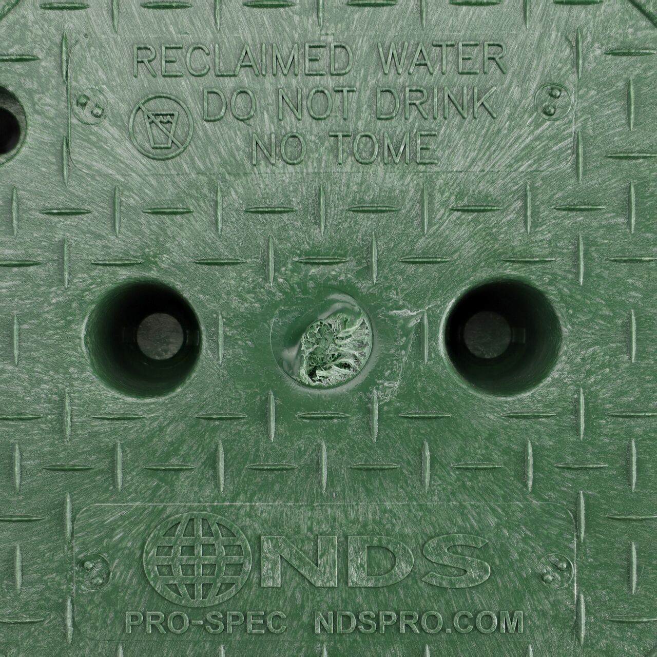 Closeup view of the Reclaimed Water markings on the Green Reclaimed Water cover (NDS 312BCRG) for the NDS 10 in. Round Pro-Spec® Series Valve Box