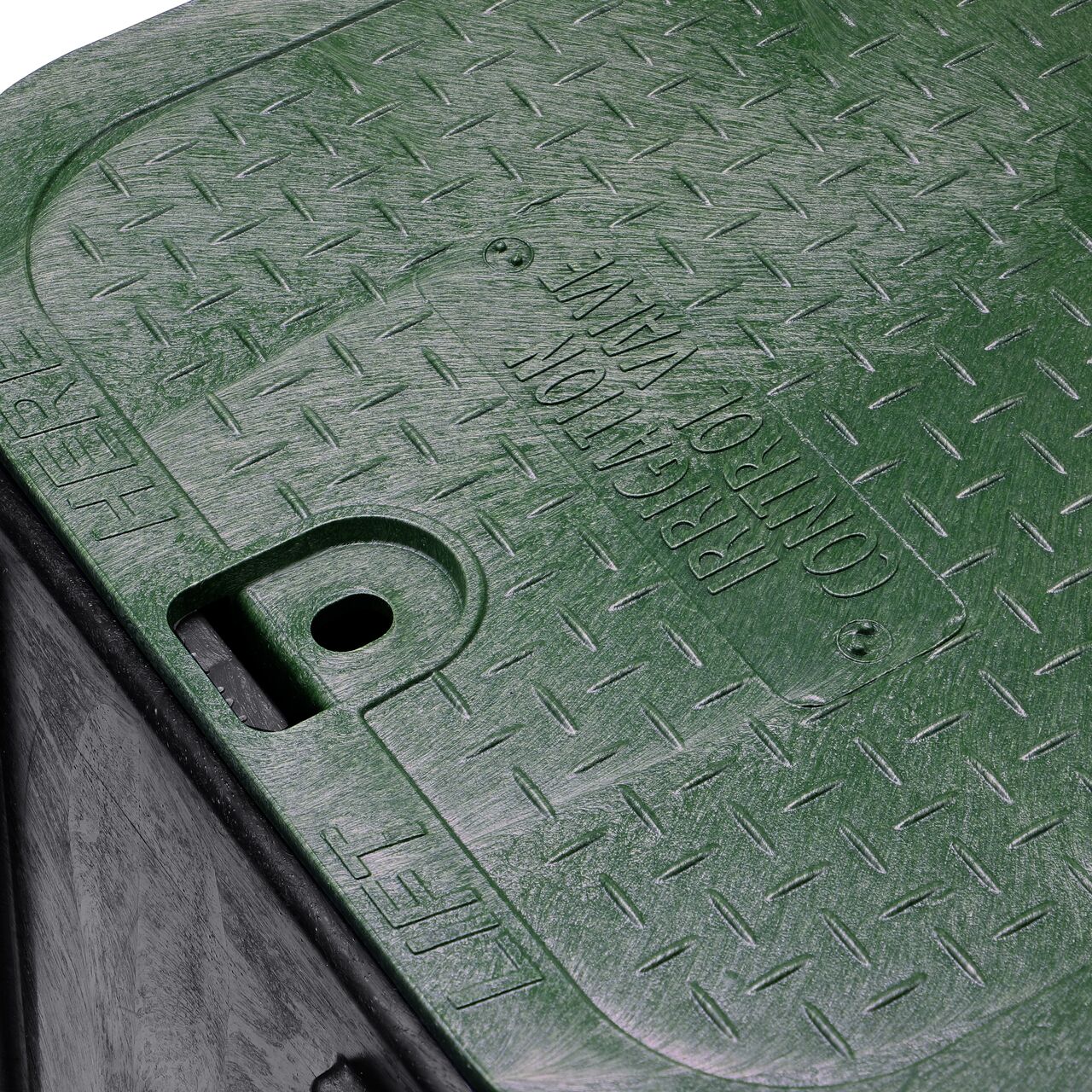 The valve box lid securely in place on the NDS 14 in. X 19 in. Rectangular Pro-Spec® Series Black Box and Green Irrigation Control Valve Cover (NDS 313BC) keeping components protected against the elements, foot traffic, lawn care equipment, and potential vandalism while keeping them out of sight