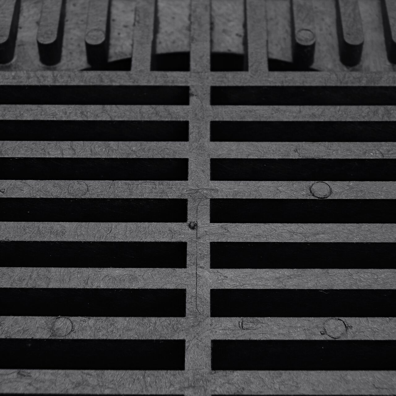 Closeup of the Grate Design on the NDS 8 in. Square Grate in Black Plastic (NDS M881, NDS 881)