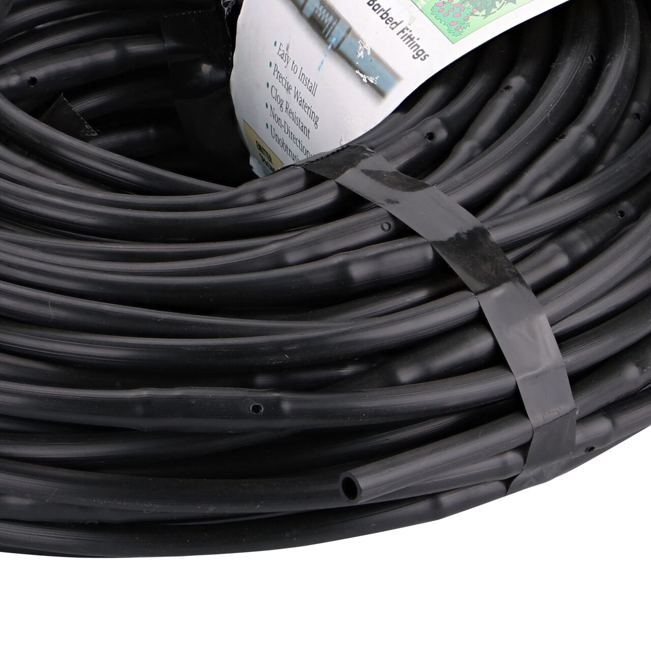 Closeup of the end of the NDS 100 ft. 1/4 in. Dura Flo™ JR Dripline with 6 in. spaced 0.5 GPH Non-Pressure Compensating Emitters (NDS SFJR-BL-06-01) with packaging tag on