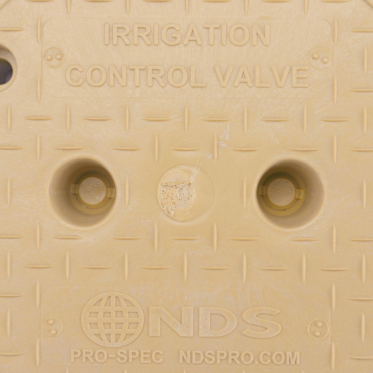 Closeup view of the Irrigation Control Valve markings on the Sand Irrigation Control Valve cover (NDS 311CSAND) for the NDS 10 in. Round Pro-Spec® Series Valve Box