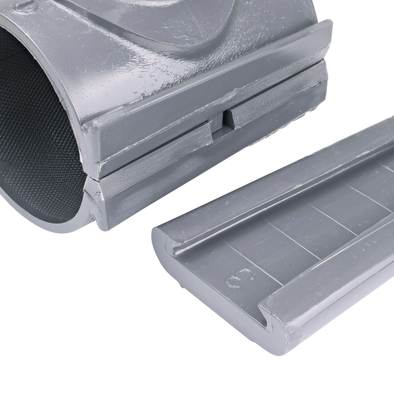 Closeup of the wedge latch uninstalled on the NDS Clamp-It™ Rigid PVC Saddle with 1-1/2 in. slip connection on top (NDS 453015) for 3 in. PVC pipe