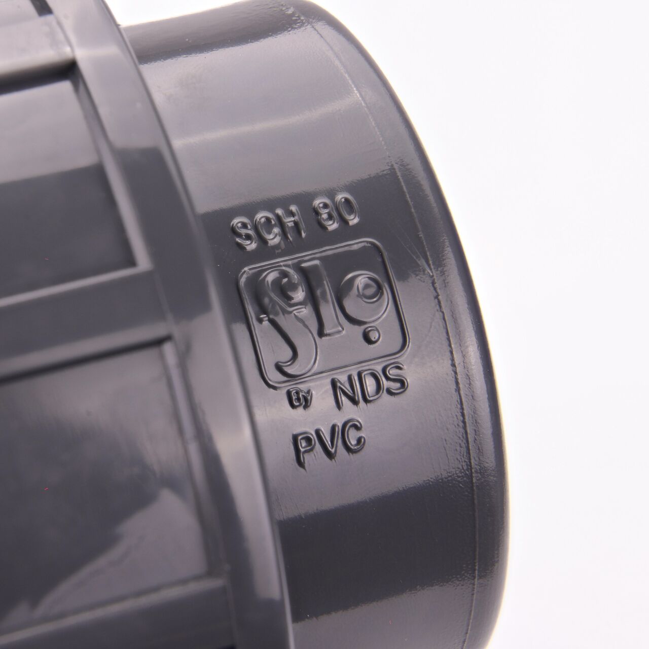 Closeup view of the writing on the NDS 2 in. PVC slip X threaded Union showing the threaded end for residential, commercial, and industrial applications (NDS U-2000-SM)