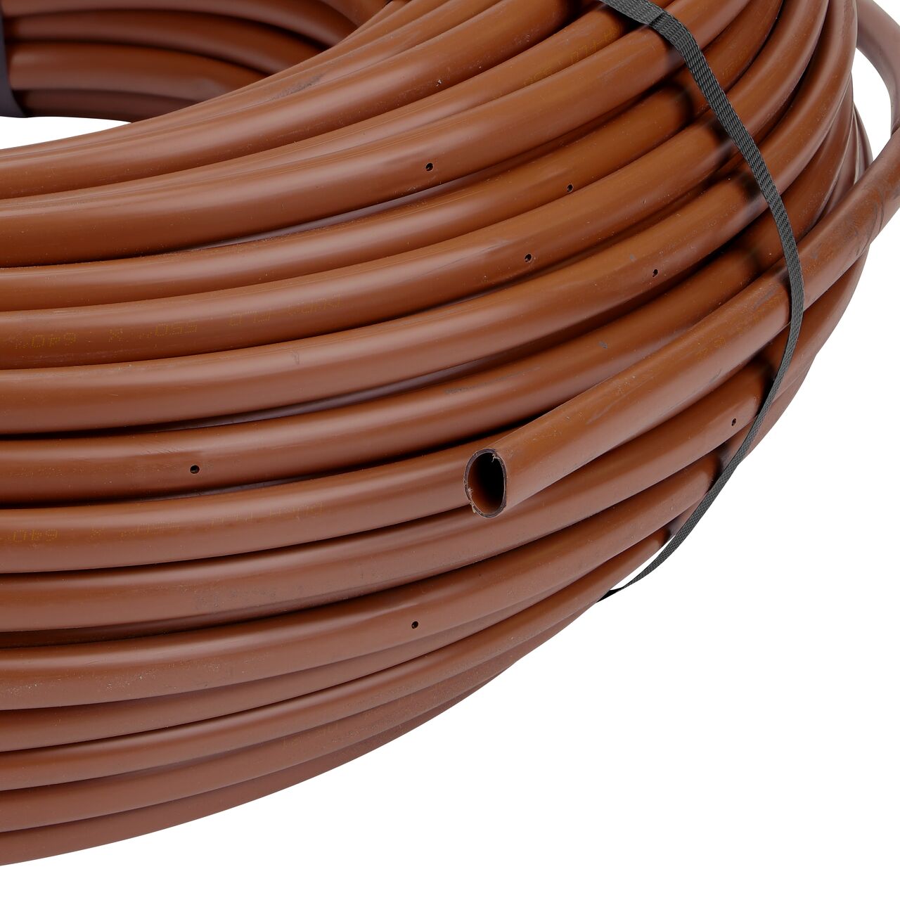 Closeup view of the outside end of the NDS 500 ft. Brown Tubing with 1.0 GPH Pressure Compensating Emitters with 12 in. Spacing (NDS SFPC-BL-6418-05)