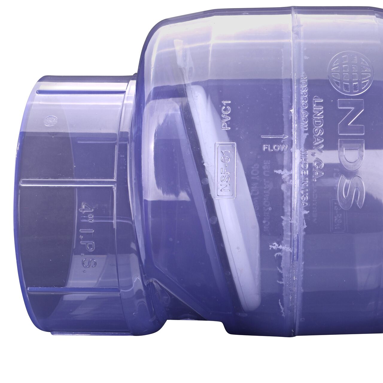 Closeup of the arrow showing water flow direction on the NDS Clear 4 in. slip end by slip end PVC Swing Check Valve (NDS 1520C40)