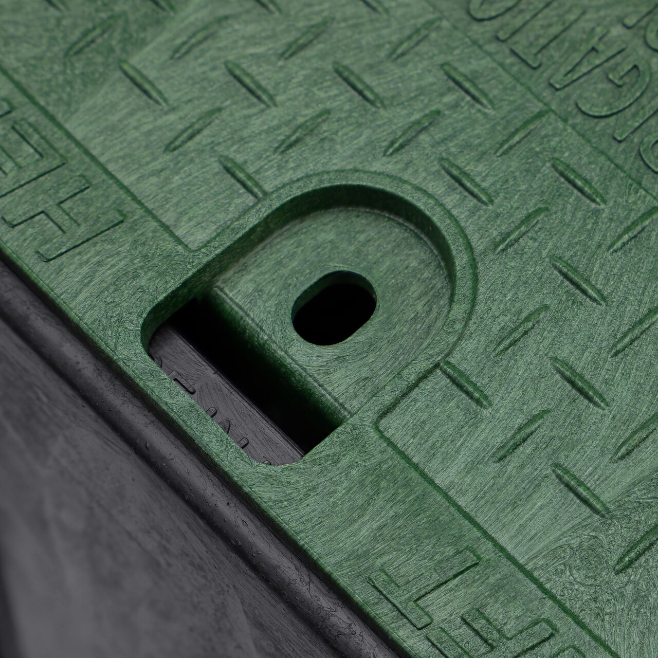 Closeup view of the traditional bolt hole on the [COLOR] NDS 14 in. X 19 in. Rectangular Pro-Spec® Series Valve Box (NDS 313BCB) for securing valve lid or cover to the valve box
