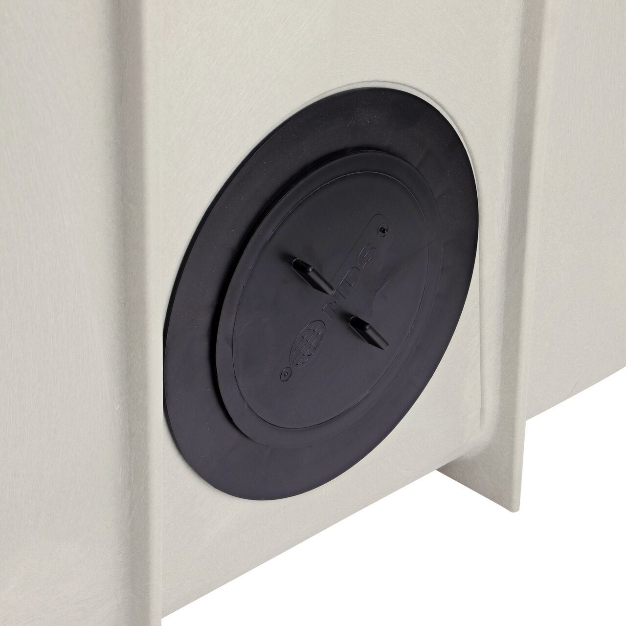 Closeup View of plug installed into outlet of the NDS Dura Slope InLine Catch Basin (NDS DS-340)