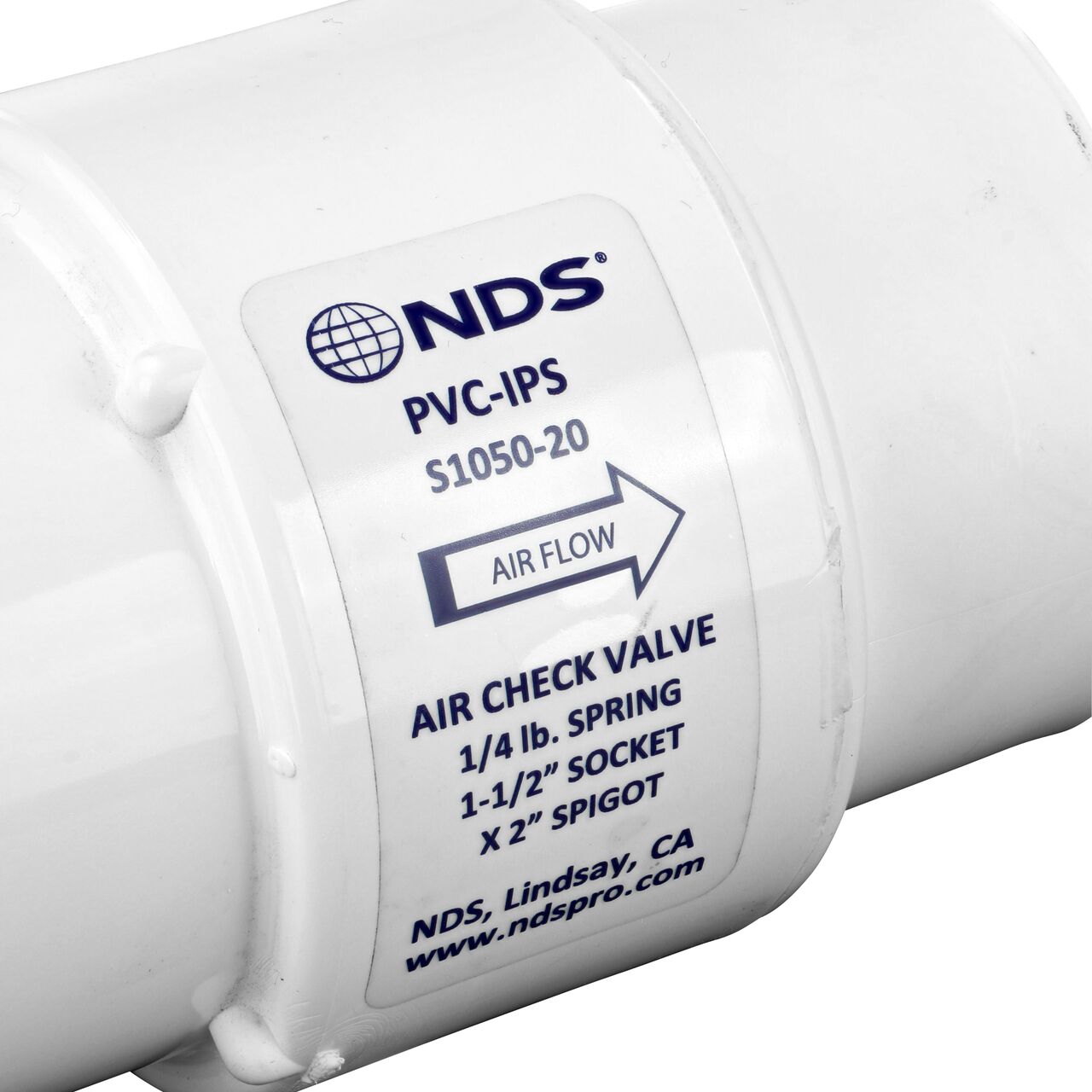 Closeup of the label showing the water flow directon on the NDS White 1-1/2 in. IPS S x 2 in. Spigot PVC Air Check Valve (NDS S1050-20)