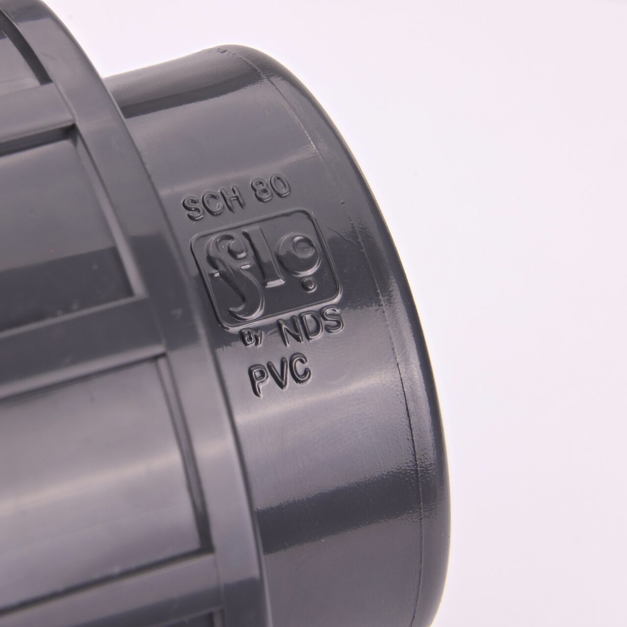 Closeup view of the NDS 2 in. PVC Union shows each end is labeled that it connects to 2 in. Schedule 80 pipe for residential, commercial, and industrial applications (NDS U-2000-S)