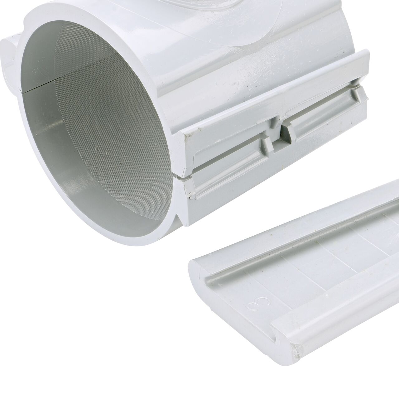 Closeup of the wedge latch uninstalled on the NDS Clamp-It™ Rigid PVC Saddle with 1-1/2 in. FPT connection on top (NDS 444015) for 4 in. PVC pipe