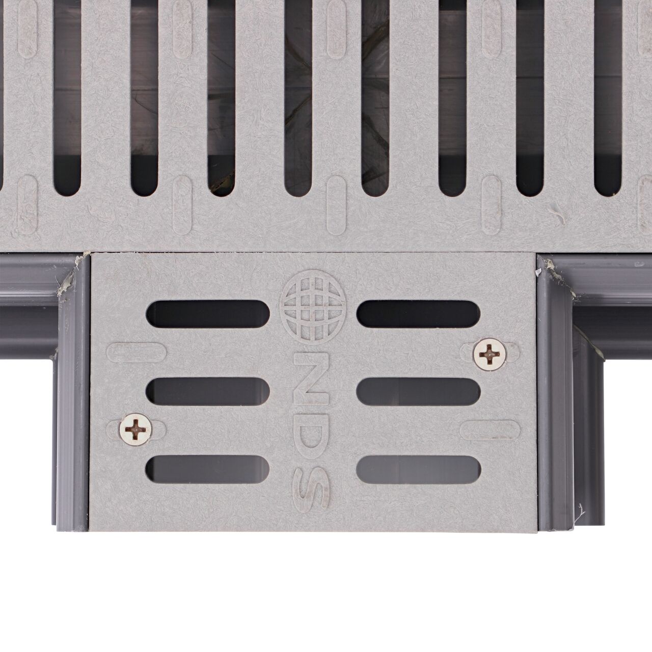 Closeup of the grate pattern of the NDS Gray Spee-D® Channel Drain Cross and Grate (NDS 2361)