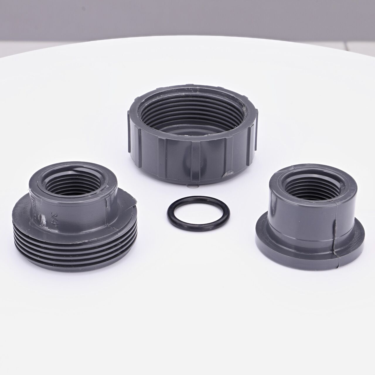 The NDS 3/4 in. FPT PVC Union shown here unassembled, includes the EPDM O-ring that is placed in the center of the union to create a leak-resistant seal (NDS U-0750-T)