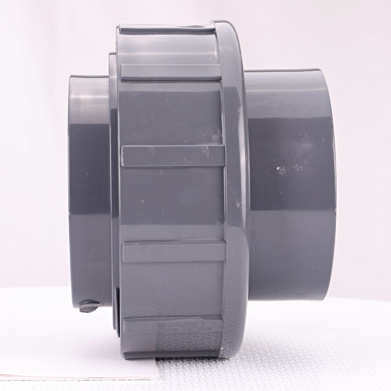 Side view of the NDS 3 in. PVC Union (NDS U-3000-T) shows both threaded ends and a pull-apart feature to quickly disconnect from pipes