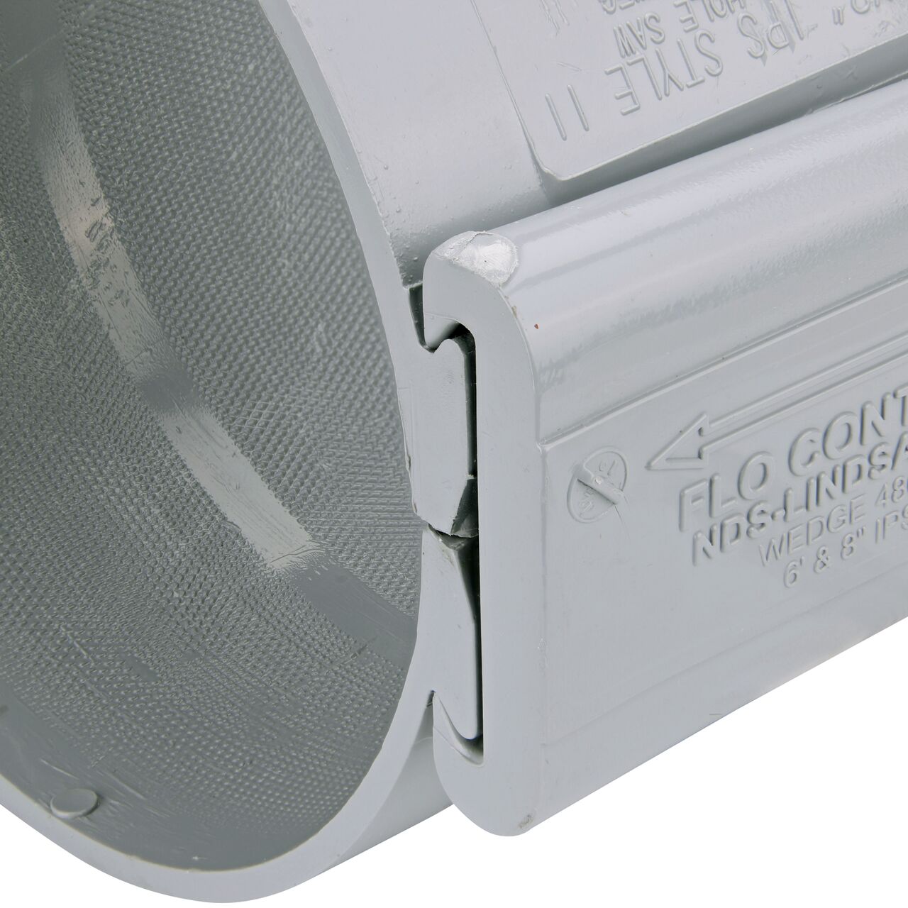 Closeup of the wedge installed securely on the NDS Clamp-It™ Rigid PVC Saddle with 2 in. FPT connection on top (NDS 446020) for 6 in. PVC pipe