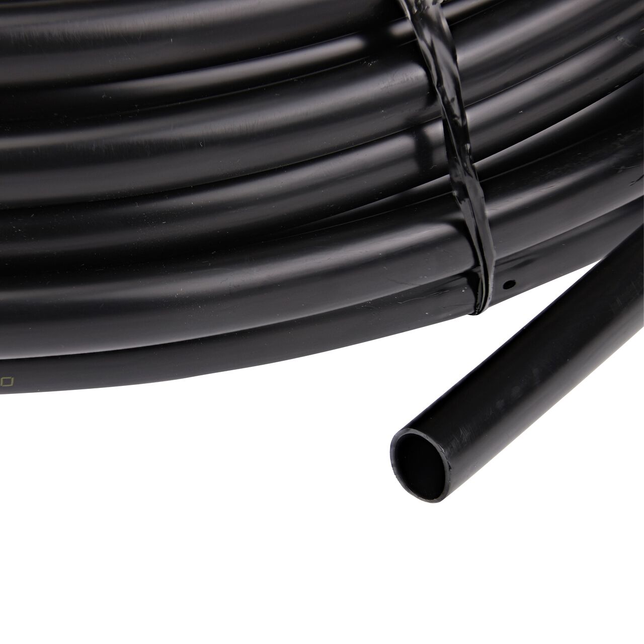 Closeup of the end of the NDS Black Tubing with 1.0 GPH Pressure Compensating Emitters iwth 12 in. Spacing to show how to pull out the dripline (NDS SFPC-6412-01)