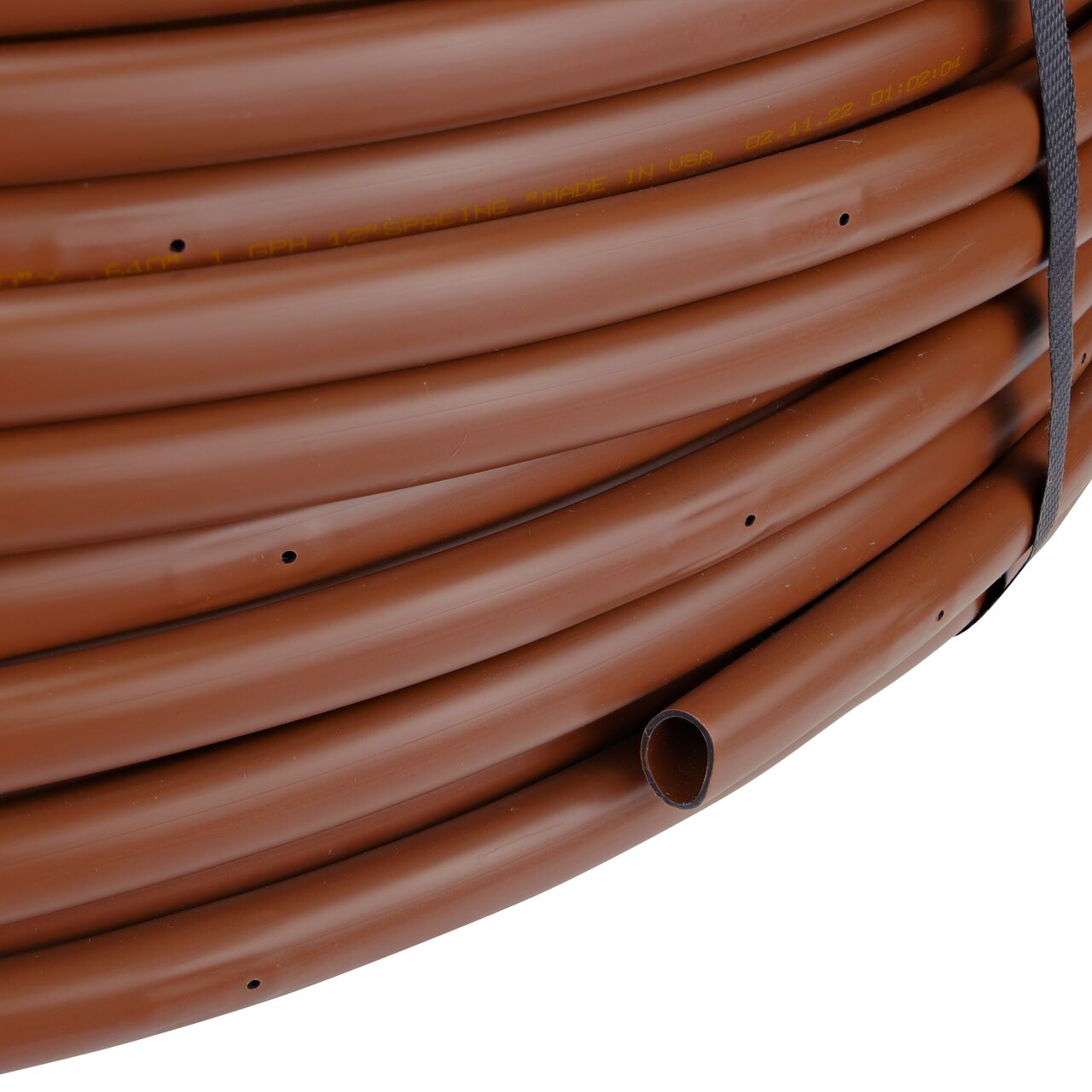 Closeup of the end of the 500 ft. NDS Brown Tubing with 1.0 GPH Pressure Compensating Emitters with 12 in. Spacing to show how to pull out the dripline (SFPC-BR-6412-05)