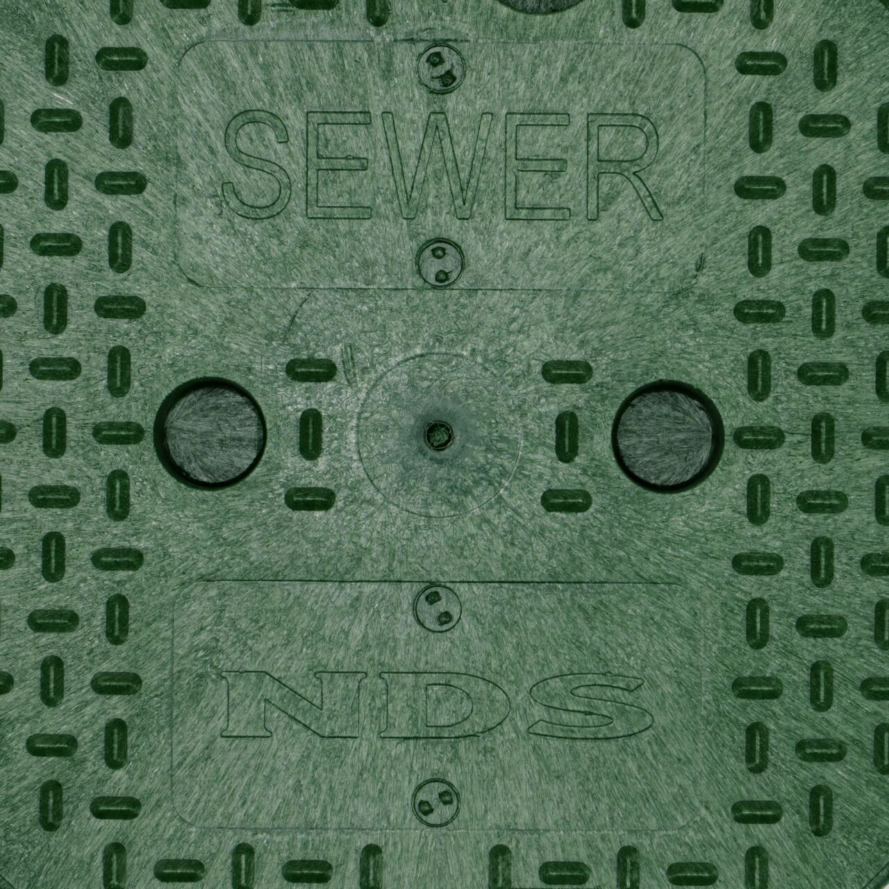Closeup view of the markings on the Green Sewer cover for the NDS 10 in. Round Standard Series Valve Box (NDS 111CS)