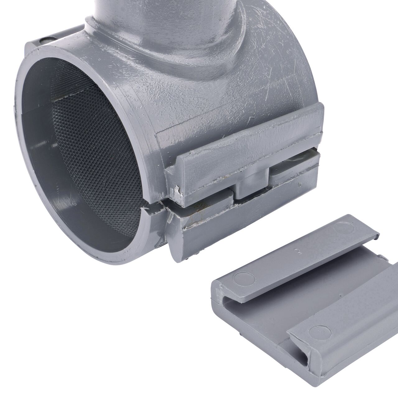 Closeup of the wedge latch uninstalled on the NDS Clamp-It™ Rigid PVC Saddle for 2 in. PE pipe with 1 in. slip on top (NDS 332010P)