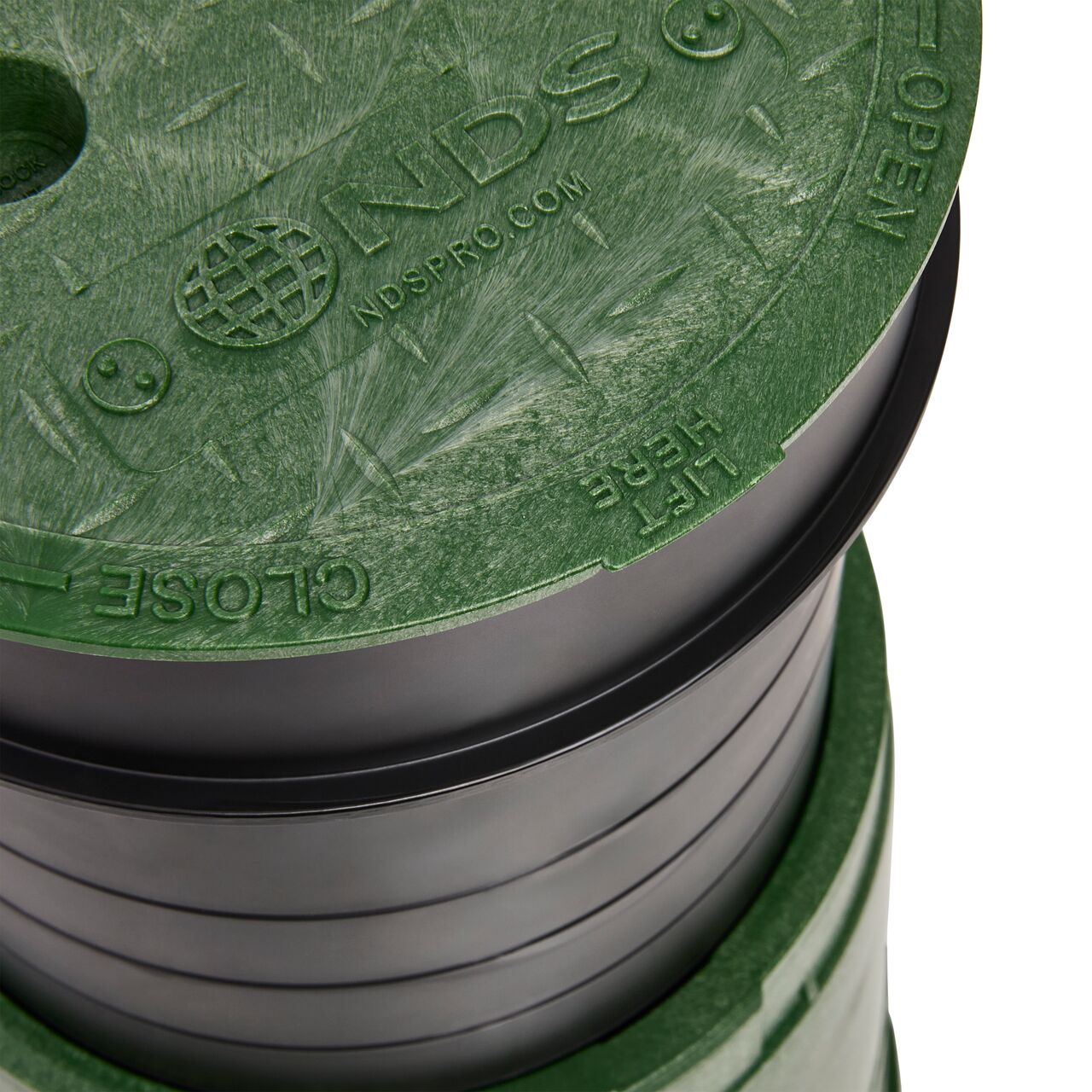 Closeup view of the 6 in. Standard Series Valve Box with the Irrigation Control Valve Secured Cover that has molded-in slip-resistant pattern and identification marking (NDS 2108BC)