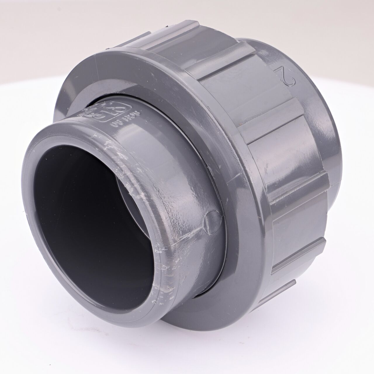 One end of the PVC Union, 2 in. Sch. 80 S X FPT which connects two 2 in. Sch. 80 pipes together to allow water to flow through while preventing leaks (NDS U-2000-ST)
