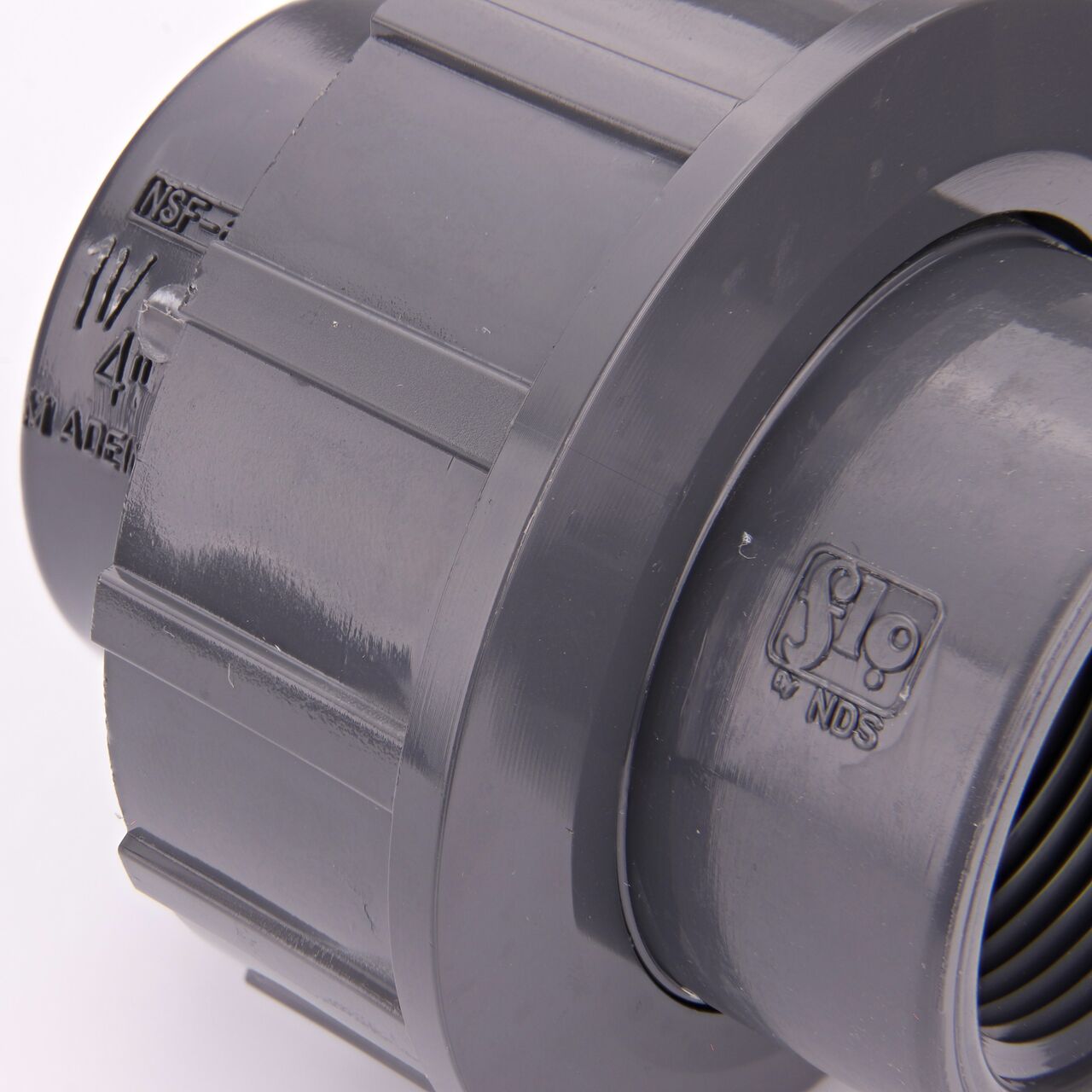 Close up view of the NDS 1-1/4 in. PVC FPT Union showing NDS brand a leader in flow management solutions and the preferred choice of professionals since 1972 mark (NDS U-1250-T)