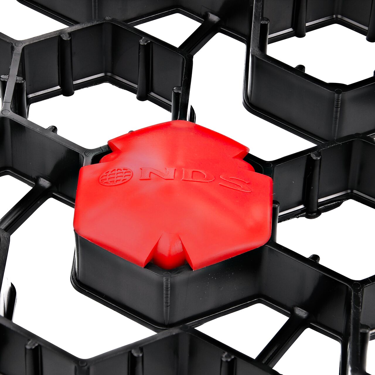 Closeup of one Red NDS EZ Marker™ Parking Delineators (NDS EZMARKER) installed in the NDS EZ Roll® Grass Pavers